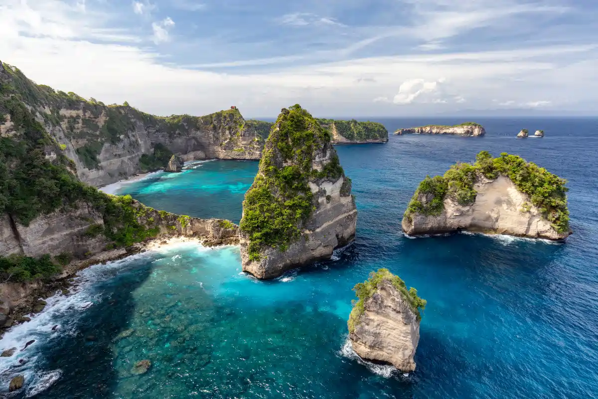 Stunning turquoise ocean and dramatic limestone cliffs along the coast near Nusa Penida Bali
