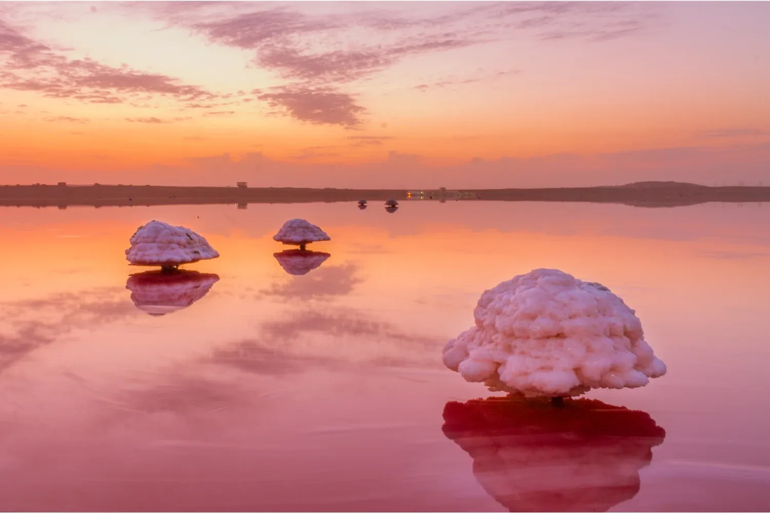 Pink waters of Lake Masazir in Azerbaijan at sunrise with salt crusts