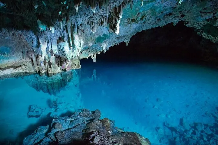 Trip Labuan Bajo exploring a cave with crystal clear blue water